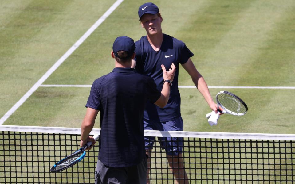 Jack Draper shakes hands with Jannik Sinner after beating him in the first round of Queen's, June 14, 2021