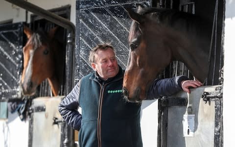 Trainer Nicky Henderson with Altior (right) in his stable during a stable visit to Seven Brarrows Stables, Lambourn - Credit: Andrew Matthews/PA