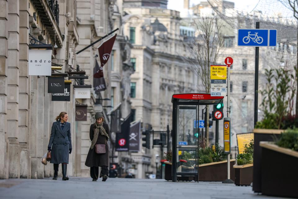 <p>Two women walk down Regent Street during England’s third national lockdown</p> (REUTERS)