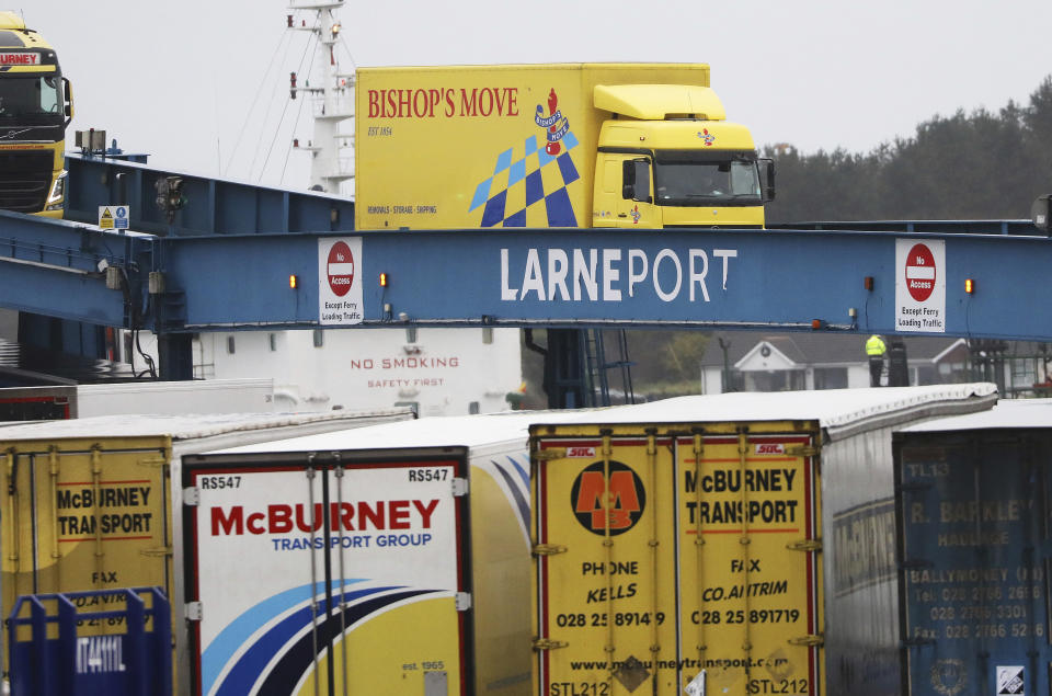 Vehicles disembark from the P&O ferry arriving from Scotland at the port of Larne, Northern Ireland, Tuesday, Feb. 2, 2021. Authorities in Northern Ireland have suspended checks on animal products and withdrawn workers from two ports after threats against border staff. (AP Photo/Peter Morrison)