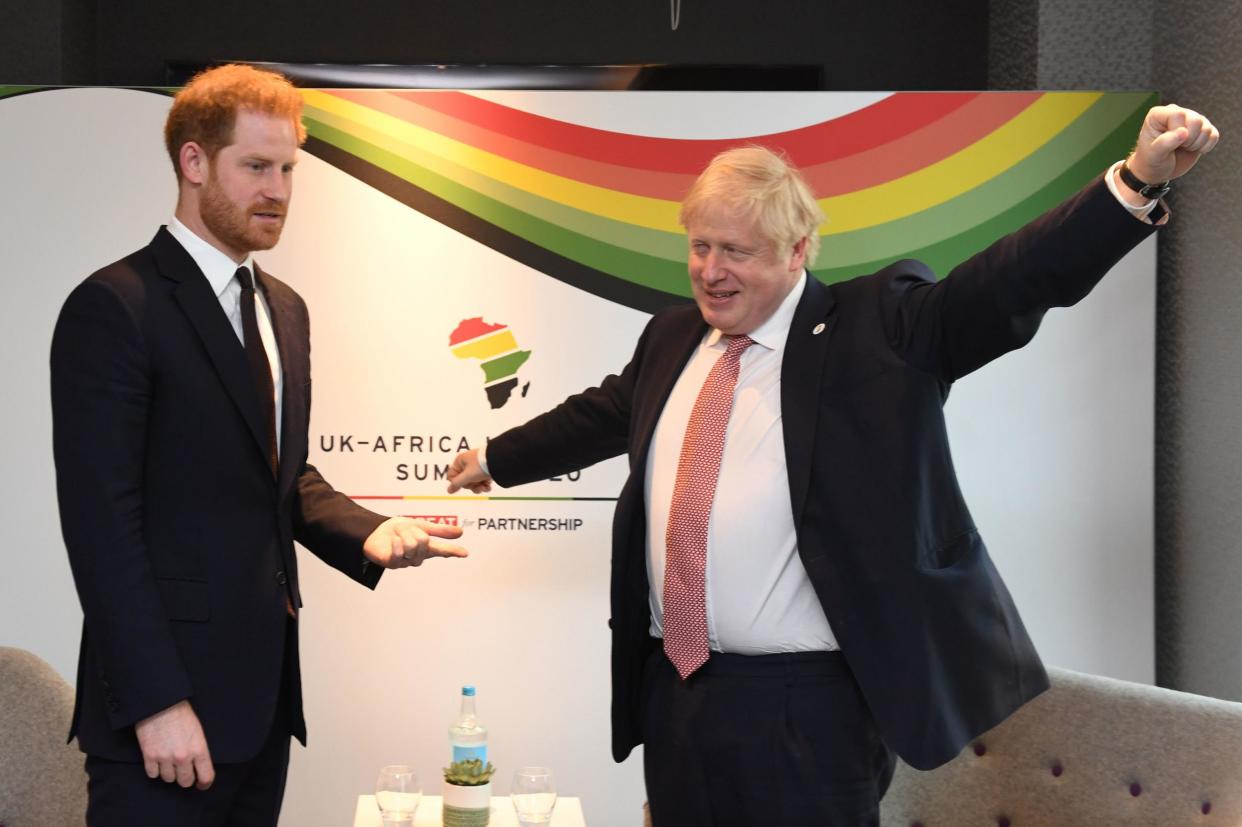 The Duke of Sussex stands beside the Prime Minister at today's event: PA