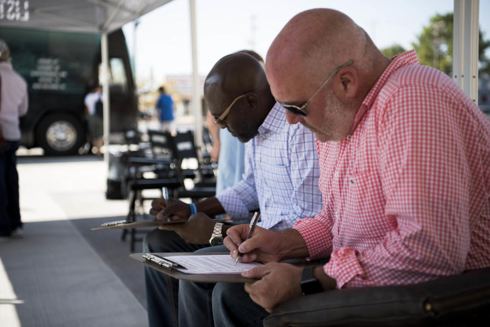 Reggie Davis, left, and Andy Nix sign up to go on the HuffPost bus.