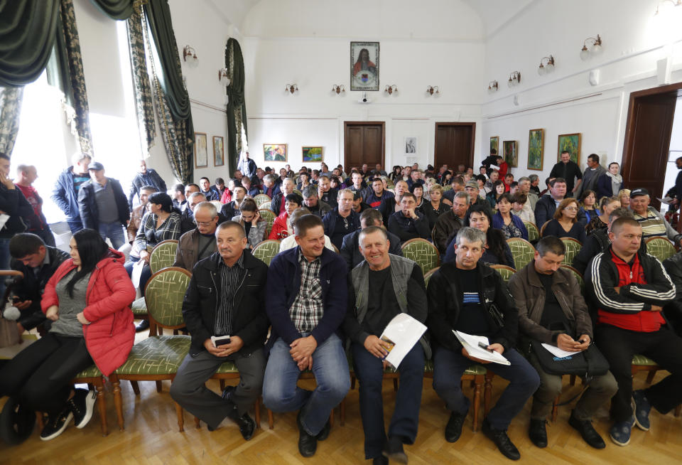 In this Friday, Oct. 19, 2018 photograph, farmers from the Hungarian minority in Ukraine attend a ceremony distributing agricultural subsidies from the Hungarian government in Beherove, Ukraine. A new education law that could practically eliminate the use of Hungarian and other minority languages in schools after the 4th grade is just one of several issues threatening this community of 120,000 people. Many are worried that even as Ukraine strives to bring its laws and practices closer to European Union standards, its policies for minorities seem to be heading in a far more restrictive direction. (AP Photo/Laszlo Balogh)