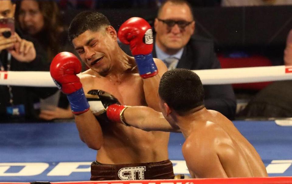 Abraham Montoya of México absorbs a punch from Gabriel Flores Jr. of Stockton in the sixth round of their junior lightweight bout at the Save Mart Center on March 4, 2022.