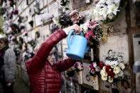 <p>Maria Luisa Mendicote waters flowers on a niche bearing the remains of her parents and a nephew at Derio cemetery on All Saints’ Day, near Bilbao, Spain, Nov. 1, 2017. (Photo: Vincent West/Reuters) </p>