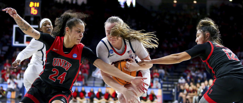 Arizona Wildcats guard Madison Conner (4) tries to break through UNLV Lady Rebels guard Essence Booker (24) and UNLV Lady Rebels guard Alyssa Durazo-Frescas (12) defense during a first round game at the NCAA women's college basketball tournament in Tucson, Ariz. Saturday, March 19, 2022. (Rebecca Sasnett, /Arizona Daily Star via AP)