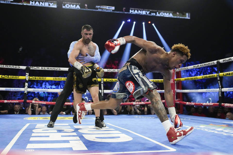 Devin Haney slips as he fights Vasiliy Lomachenko in an undisputed lightweight championship boxing match Saturday, May 20, 2023, in Las Vegas. Haney won by unanimous decision. (AP Photo/John Locher)