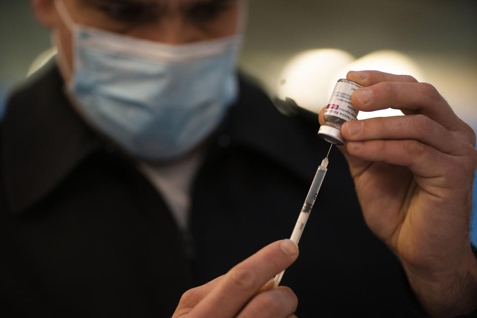 A nurse prepares a dose of the AstraZeneca vaccine at the Nestor Kirchner Cultural Center, the largest cultural center in Latin America, where security forces are being vaccinated for COVID-19 in Buenos Aires, Tuesday, June 15, 2021. Argentina is speeding up its vaccination process amid a severe, second wave. (AP Photo/Victor R. Caivano)