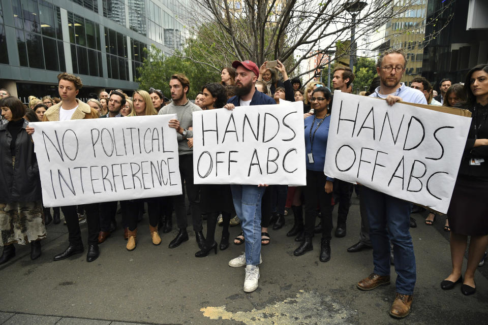 In this Wednesday, Sept. 26, 2018, photo, Australian Broadcasting Corp. staff hold placards outside their offices in Sydney, Australia. The chairman of the Australian Broadcasting Corp. resigned on Thursday over allegations that he pressured the independent national broadcaster to fire two political journalists because the government disliked them. (Joel Carrett/AAP Image via AP)