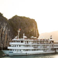 Small cruise ship sailing through Halong Bay.