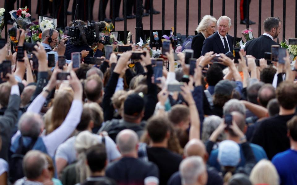 The King and Queen are cheered by a crowd of hundreds outside Buckingham Palace - REUTERS/John Sibley