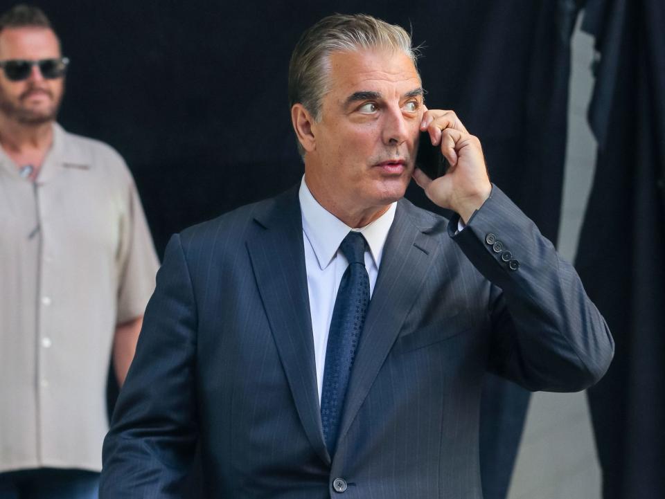 chris noth on set of and just like that speaking on the phone