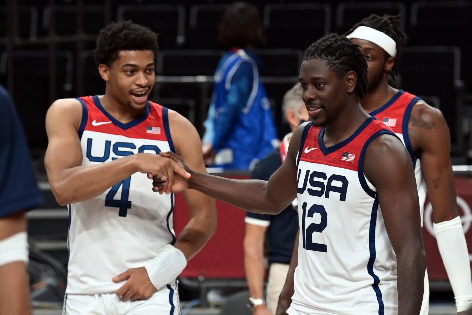 Pictured here, USA's Keldon Johnson (L) and Jrue Holiday (R) celebrate their victory against the Boomers.