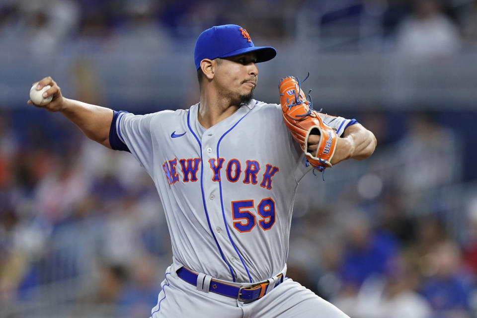 New York Mets' Carlos Carrasco delivers a pitch during the first inning of a baseball game against the Miami Marlins, Saturday, July 30, 2022, in Miami. (AP Photo/Wilfredo Lee)