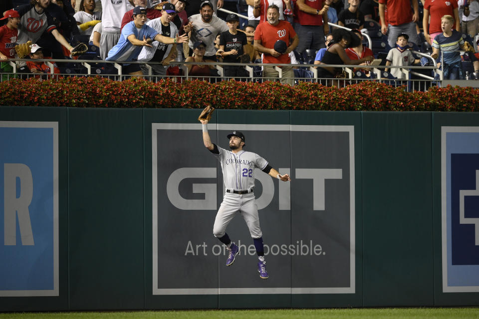Colorado Rockies left fielder Sam Hilliard (22) makes a catch on a ball hit by Washington Nationals' Yadiel Hernandez for the out during the fourth inning of a baseball game Friday, Sept. 17, 2021, in Washington. (AP Photo/Nick Wass)