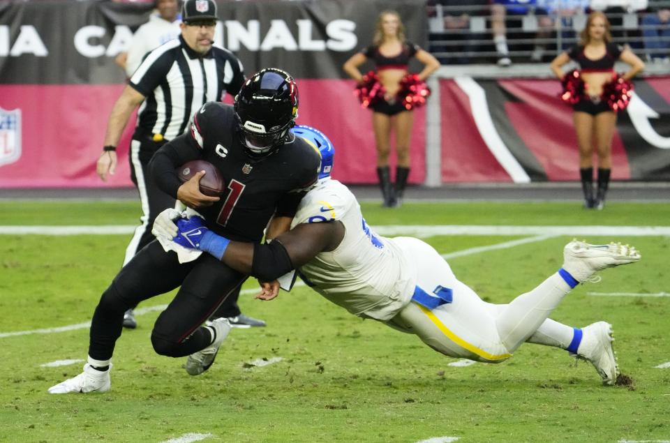 Arizona Cardinals quarterback Kyler Murray (1) is sacked by Los Angeles Rams defensive tackle Kobie Turner (91) in the second half at State Farm Stadium in Glendale on Nov. 26, 2023.