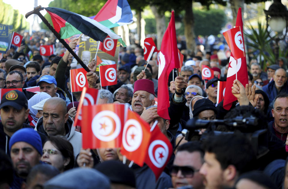 People commemorate the 13th anniversary of the Tunisian uprising in Avenue Habib Bourguiba, Tunis, Sunday, Jan. 14, 2024. (AP Photo/Hassene Dridi)