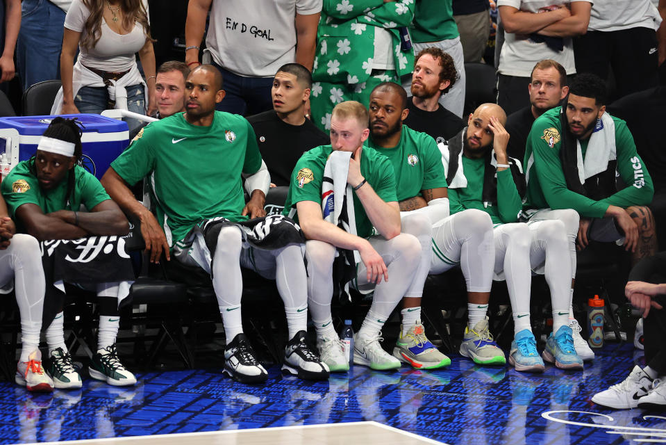 The Celtics bench looks on in disbelief during the fourth quarter of their blowout loss. (Stacy Revere/Getty Images)