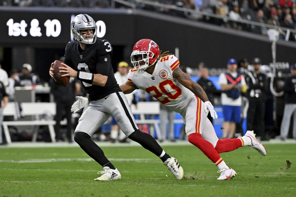 Las Vegas Raiders quarterback Jarrett Stidham, left, is sacked by Kansas City Chiefs safety Justin Reid (20) during the first half of an NFL football game Saturday, Jan. 7, 2023, in Las Vegas. (AP Photo/David Becker)