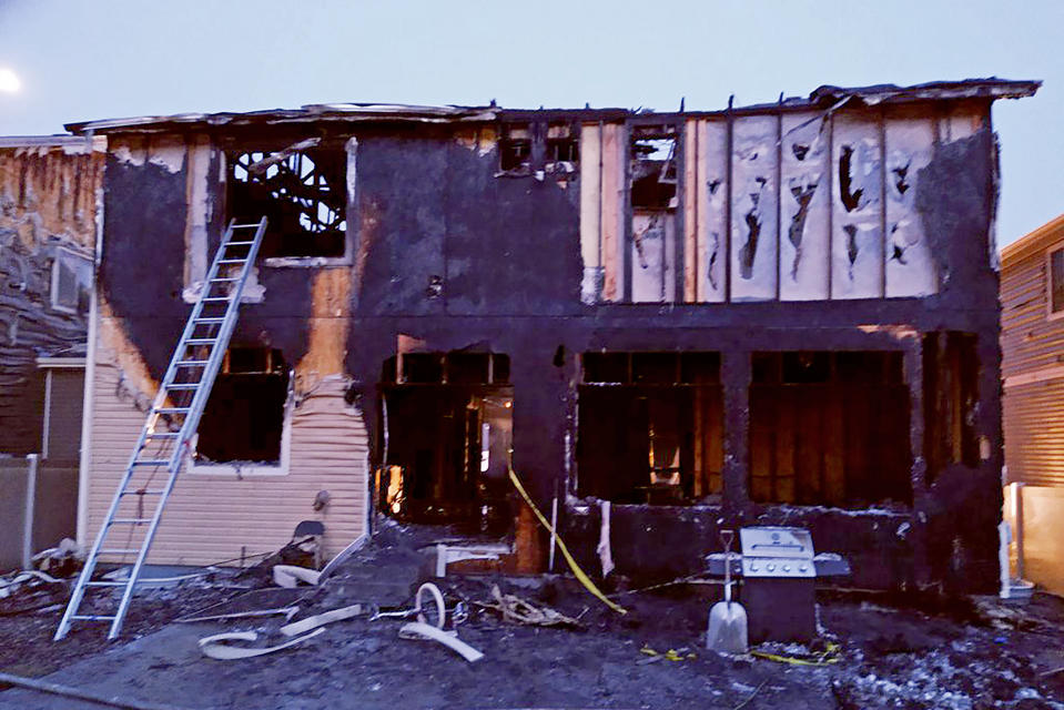 This photo from the Denver Fire Department shows the house where five people were found dead in fire that authorities suspect was intentionally set, early Wednesday, Aug. 5, 2020. Firefighters believe that the victims were two children and three adults. A Denver Fire Department spokesman says three people who were on the the upper story of the house managed to escape but the fire's heat pushed back a police officer trying to rescue those on the first floor. (Denver Fire Department via AP)