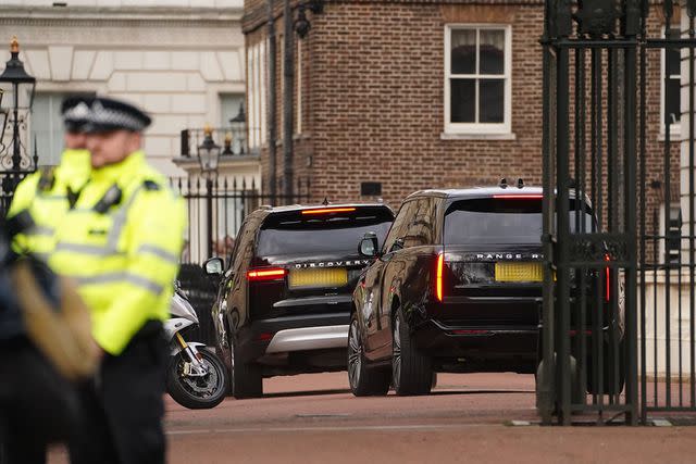 <p>James Manning/PA Images via Getty</p> Two black SUVs, believed to be carrying Prince Harry, arrive at King Charles' residence on Feb. 6, 2024