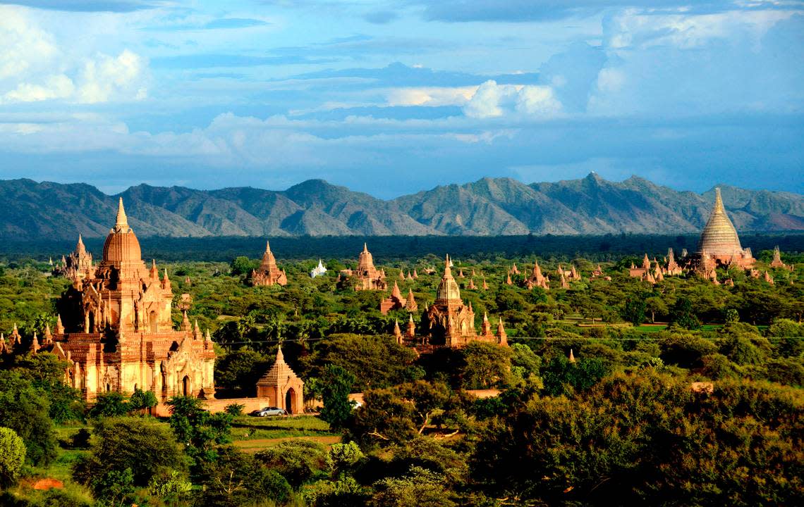 In this Aug. 15, 2013 photo, ancient temples stand in Bagan, central Myanmar. After closing its doors to the West for half a century, Myanmar has reopened, inviting all to come and discover its treasures, ancient palaces of kings long gone, legends and mysteries told in stone. With ill-equipped roads and railways, there is no better way to explore than by river. Public ferries crisscross through glistening green paddies; old teak fishing boats can be rented by the day. (AP Photo/Khin Maung Win)