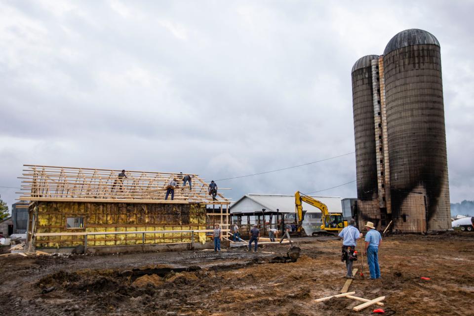 Friends and family help Dan Imhoff rebuild a barn that burnt down Tuesday, Sept. 21, 2021, near Wakarusa.