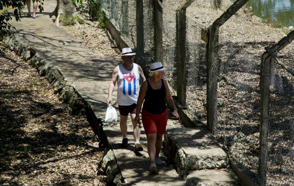 In this May 13, 2019 photo, tourists visit a crocodile farm in the Zapata Peninsula, Matanzas, Cuba. Across the Florida Straits, the Trump administration is intently focused on cutting back on Cuban tourism as part of a campaign to drown the Cuban economy and force its government to sever ties with President Nicolas Maduro’s government in Venezuela. (AP Photo/Ismael Francisco)