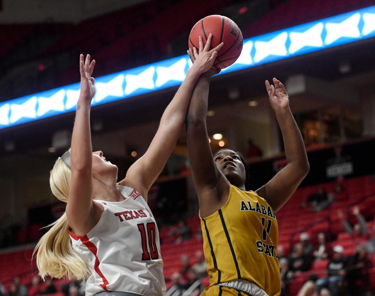 Texas Tech's forward Bryn Gerlich (10), left, attempts to block Alabama State's guard Samiya Steele's (11) layup in a non-conference basketball game, Thursday, Dec. 1, 2022, at United Supermarkets Arena.