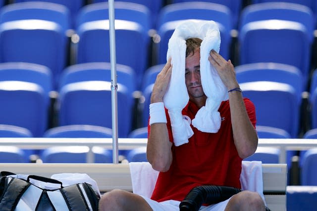 Daniil Medvedev tries to cool down with use of an ice towel