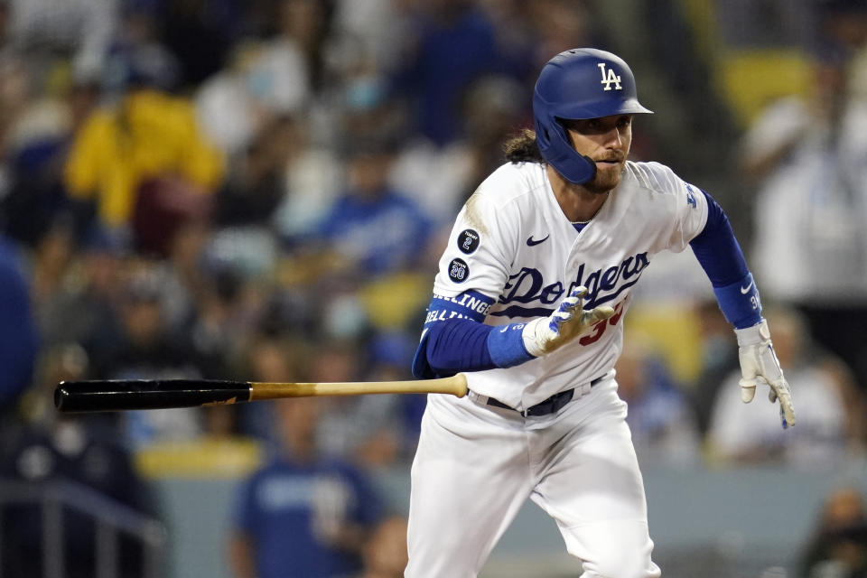 Los Angeles Dodgers' Cody Bellinger drops his bat as he doubles during the seventh inning of a baseball game against the Arizona Diamondbacks Monday, Sept. 13, 2021, in Los Angeles. (AP Photo/Marcio Jose Sanchez)
