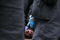 Riot police arrests a protester who shouted 'I can't breathe' after taking part in a 'We Do Not Consent' rally at Trafalgar Square, organised by Stop New Normal, to protest against coronavirus restrictions, in London, Saturday, Sept. 26, 2020. (AP Photo/Frank Augstein)