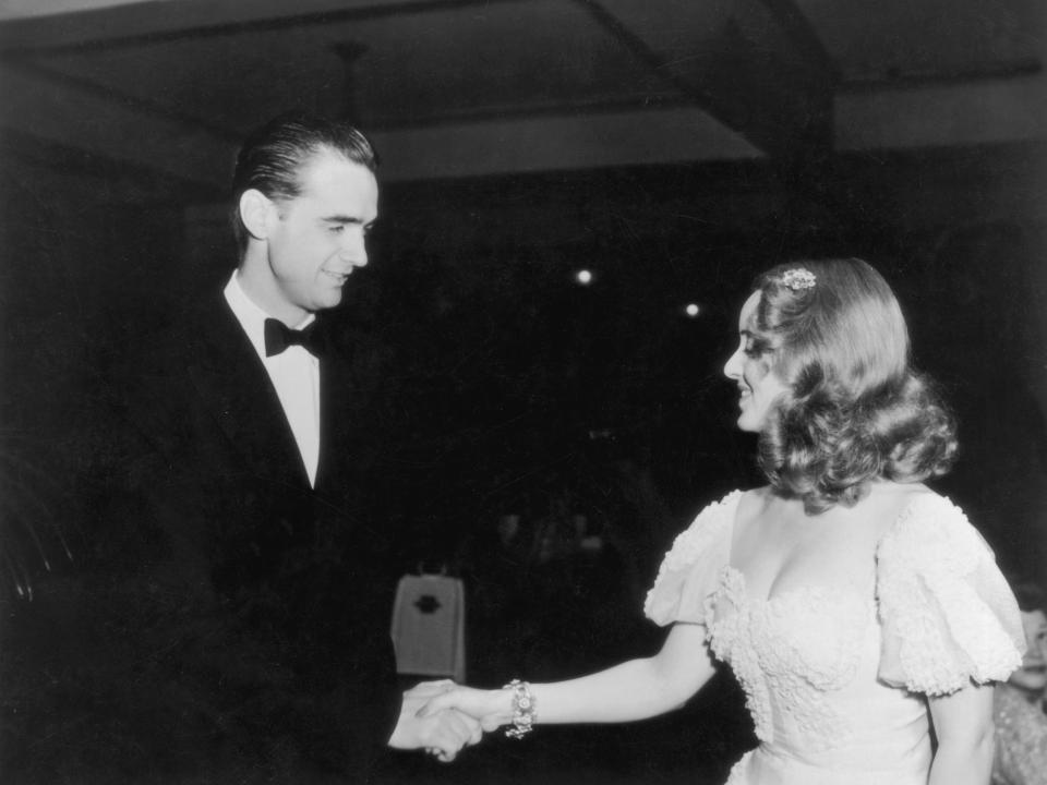 Howard Hughes shakes Bette Davis’ hand in 1938.