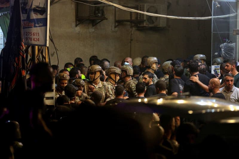 Lebanese army soldiers and pro-Iranian Hezbollah militants secure the entrance of a building that was targeted by an Israeli drone in Beirut's southern suburb. The Israeli military said Tuesday it has carried out a "targeted attack" on a commander of the pro-Iranian Hezbollah militia in Beirut.  The explosion occurred three days after a deadly rocket attack on the Israeli-occupied Golan Heights. Marwan Naamani/dpa