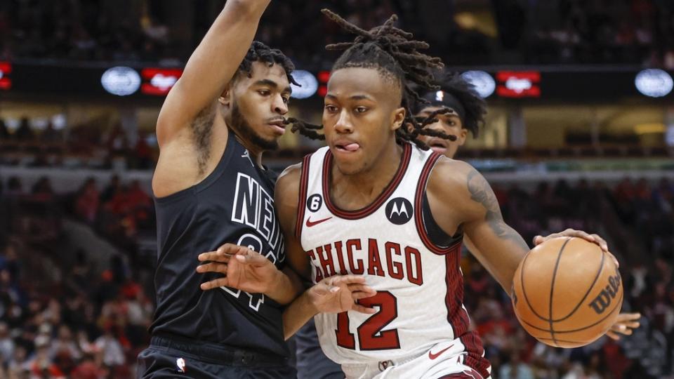 Feb 24, 2023; Chicago, Illinois, USA; Chicago Bulls guard Ayo Dosunmu (12) drives to the basket against Brooklyn Nets guard Cam Thomas (24) during the first half at United Center.