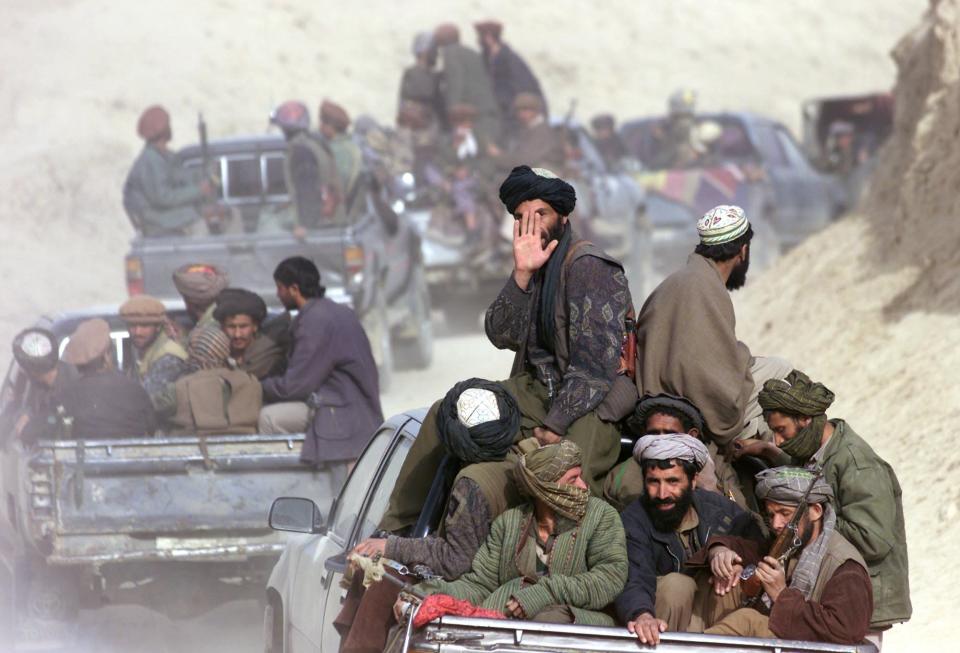 FILE - In this Saturday, Nov. 24, 2001 file photo, defecting Taliban fighters drive through the front line in the village of Amirabad, northern Afghanistan. Secret contacts are again reported to be underway for an Afghanistan peace deal, but neither analysts nor the belligerents see hope they will succeed. (AP Photo/Dusan Vranic, File)