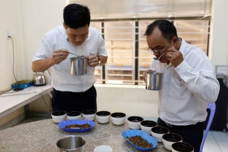 Thai Anh Tuan a manager of Simexco Dak Lak Limited coffee company tastes coffee at his office in the town of Di An in Binh Duong province