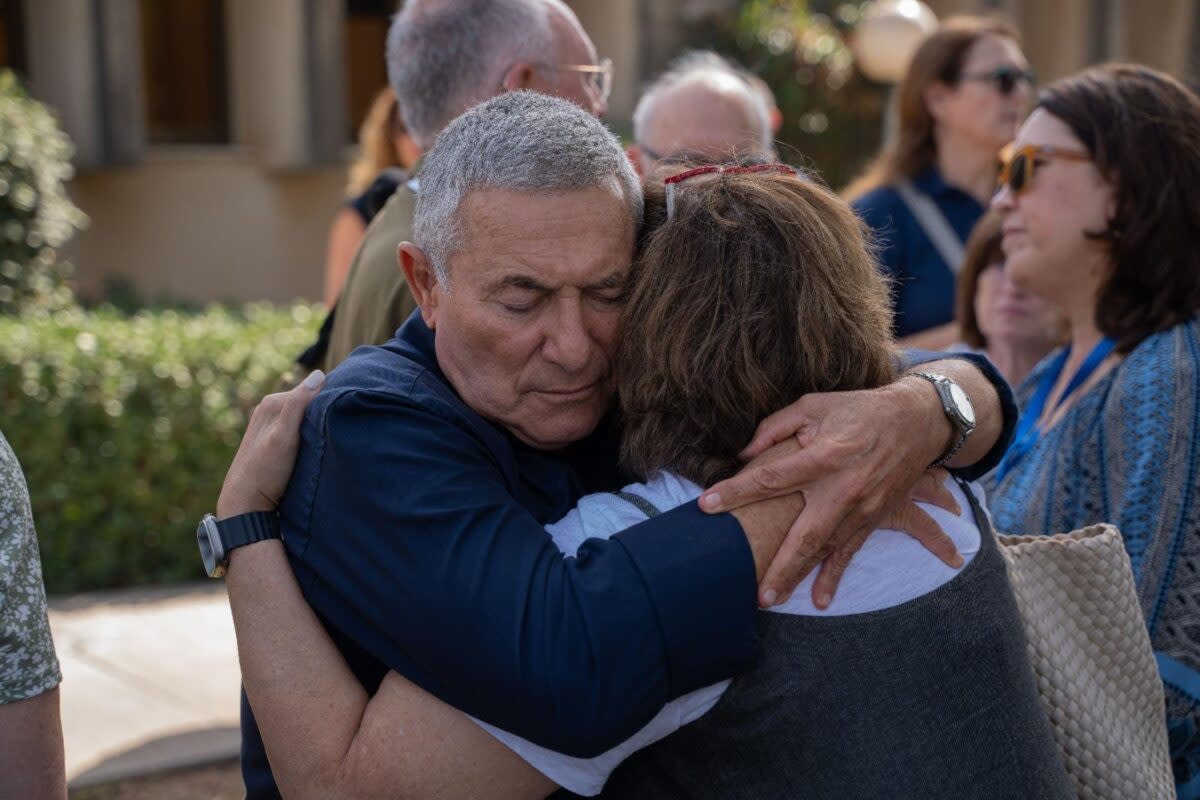 Doron Almog, chairman of the executive of the Jewish Agency for Israel, embraces a JAFI board member at an emergency board meeting at Kibbutz Shfayim where he discussed the importance of the solidarity of the global Jewish community.