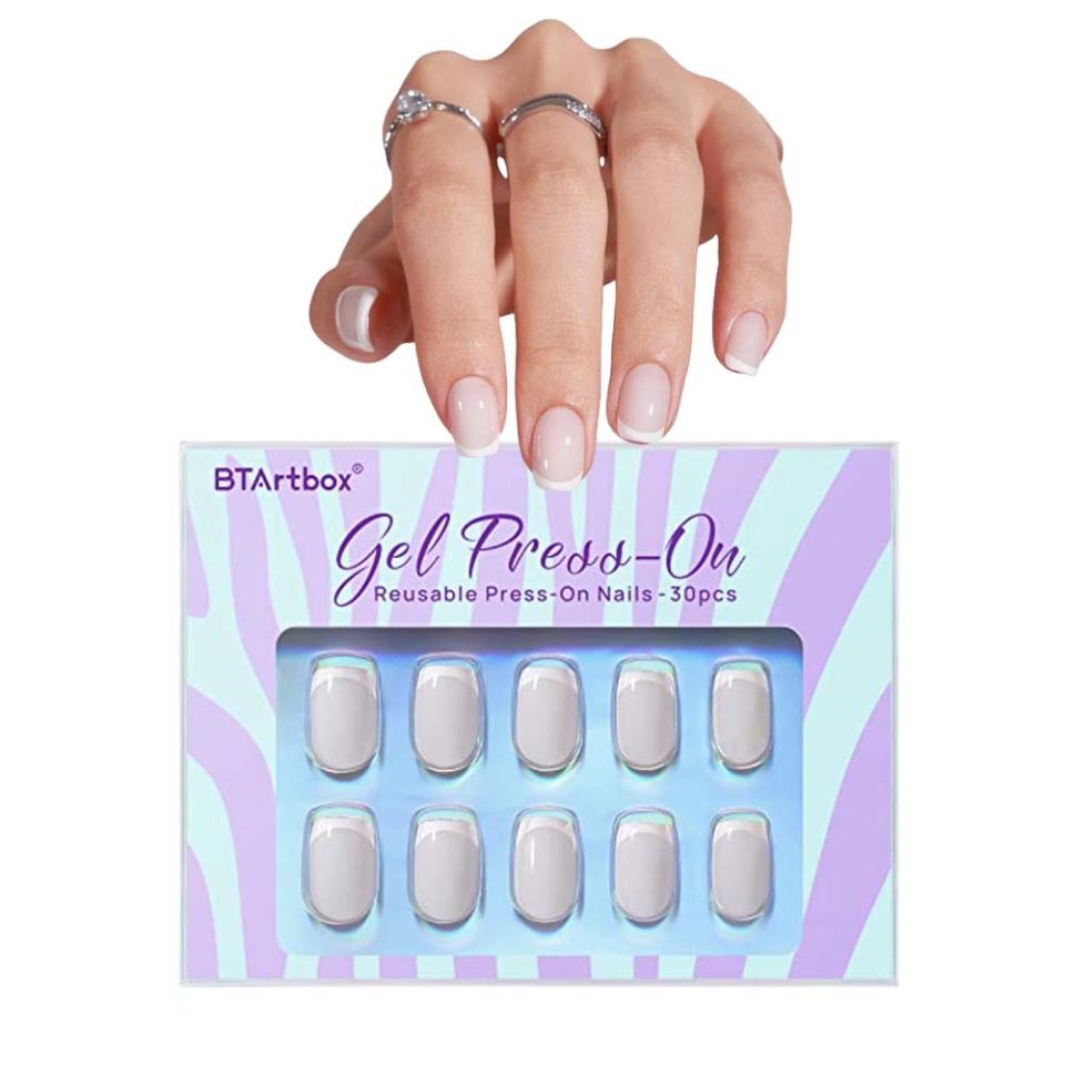 hand wearing French tip press-on nails with press-on nail kit