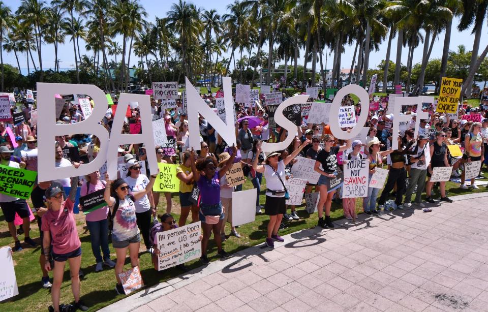 People attend an abortion-rights rally and march sponsored by the League of Women Voters held at the Meyer Amphitheater in downtown West Palm Beach on Saturday, May 14, 2022.