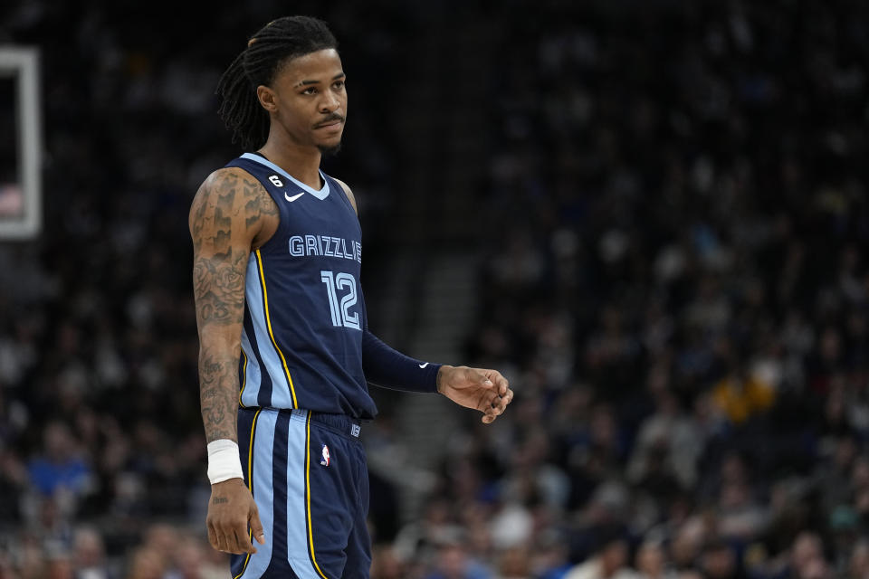 Memphis Grizzlies guard Ja Morant (12) waits for play to resume during the second half of an NBA basketball game against the Minnesota Timberwolves, Friday, Jan. 27, 2023, in Minneapolis. (AP Photo/Abbie Parr)