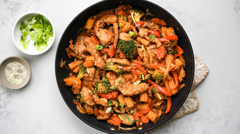 garnished pork stir-fry in skillet