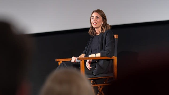 Sofia Coppola sitting in a chair talking to an audience.