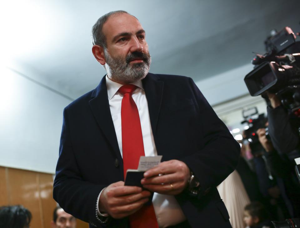 Acting Armenian Prime Minister Nikol Pashinian arrives to cast his ballot in an early parliamentary election in Yerevan, Armenia, Sunday, Dec. 9, 2018. The charismatic 43-year-old Nikol Pashinian took office in May after spearheading massive protests against his predecessor's power grab that forced the politician to step down. (Vahan Stepanyan/PAN Photo via AP)