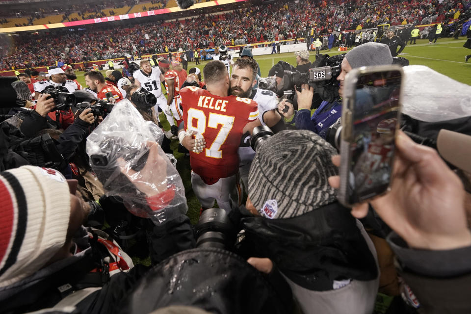 FILE - Kansas City Chiefs tight end Travis Kelce (87) hugs his brother, Philadelphia Eagles center Jason Kelce following an NFL football game Monday, Nov. 20, 2023, in Kansas City, Mo. The Eagles won 21-17. Jason Kelce has retired after 13 seasons with the Eagles. Kelce officially called it quits Monday, March 4, 2024, at the Eagles’ complex in Philadelphia.(AP Photo/Charlie Riedel, File)