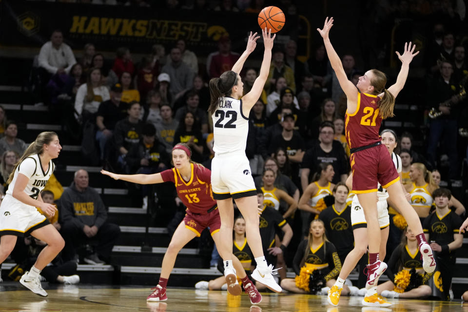 Iowa guard Caitlin Clark (22) shoots over Iowa State guard Lexi Donarski (21) during the first half of an NCAA college basketball game, Wednesday, Dec. 7, 2022, in Iowa City, Iowa. (AP Photo/Charlie Neibergall)