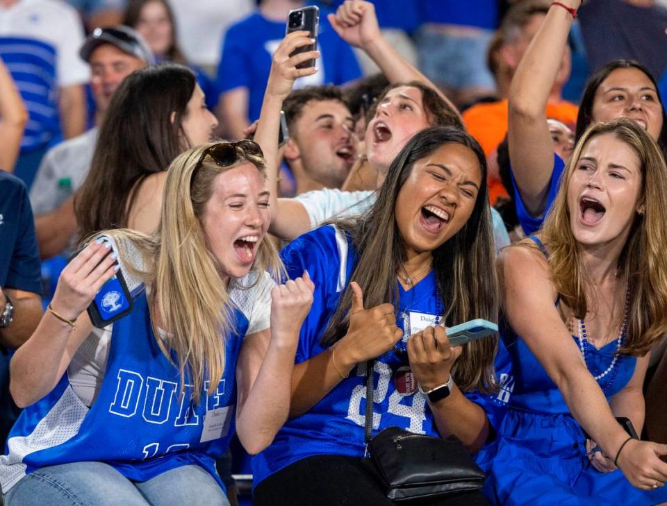 Duke student Isabella Kohn, left, and fellow Blue Devil fans relish in the final minutes of play before storming the field to celebrate their 28-7 victory over Clemson on Monday, September 4, 2023 at Wallace Wade Stadium Stadium in Durham, N.C.