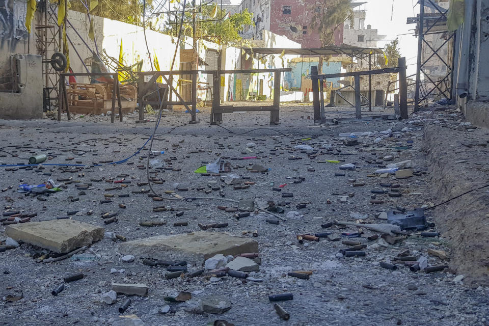 Empty bullet cartridges are seen lying on the road during a third day of clashes that erupted between members of Palestinian President Mahmoud Abbas' Fatah group and Islamist factions in the Palestinian refugee camp of Ein el-Hilweh near the southern port city of Sidon, Lebanon, Monday, July 31, 2023. (AP Photo/Mohammad Zaatari)