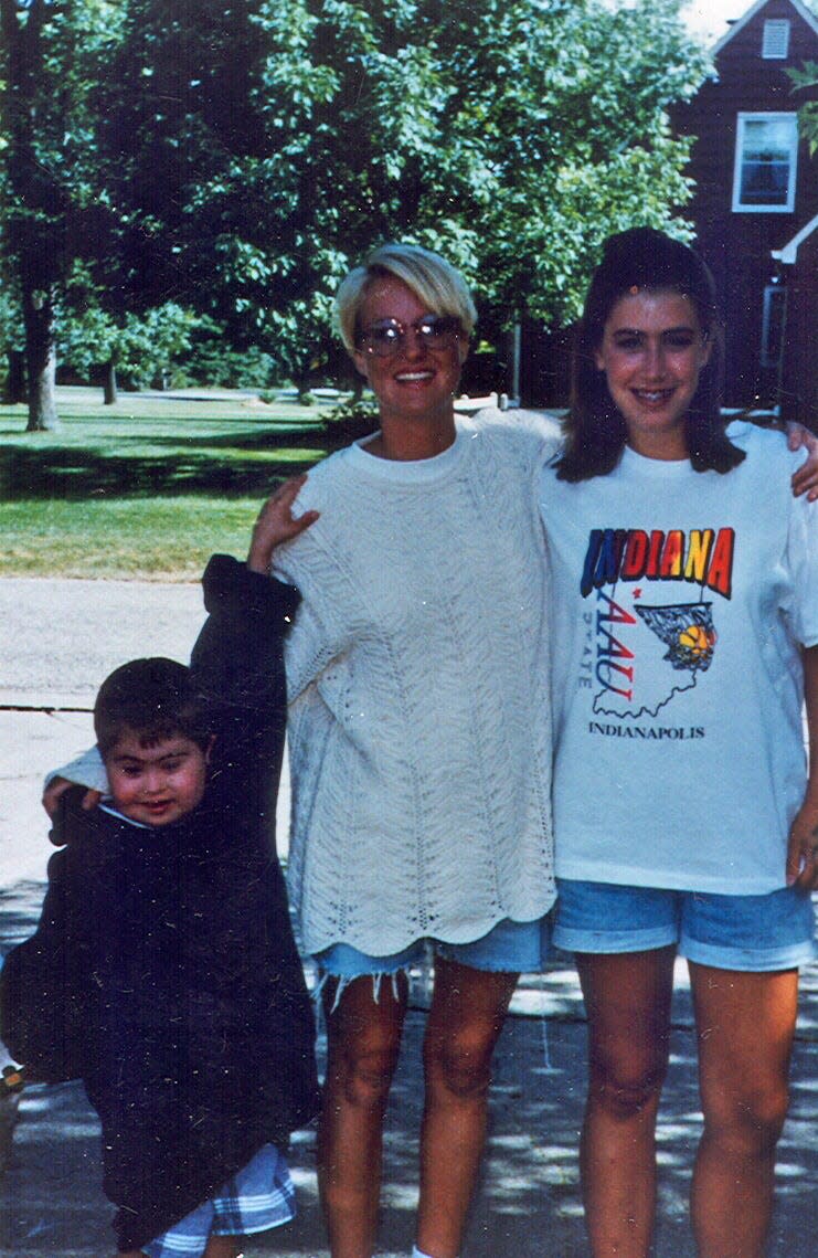 Kristin Schoonveld (middle) is shown with a young Nick Schoonveld (left) and his sister Kim more than 20 years ago when she babysat for the family.