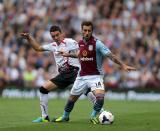 Liverpool's Iago Aspas (left) and Aston Villa's Antonio Luna (right) battle for the ball